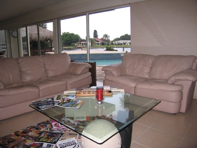 Lovely living room with a view of the pool, and a lot of crap sitting on our coffee table!