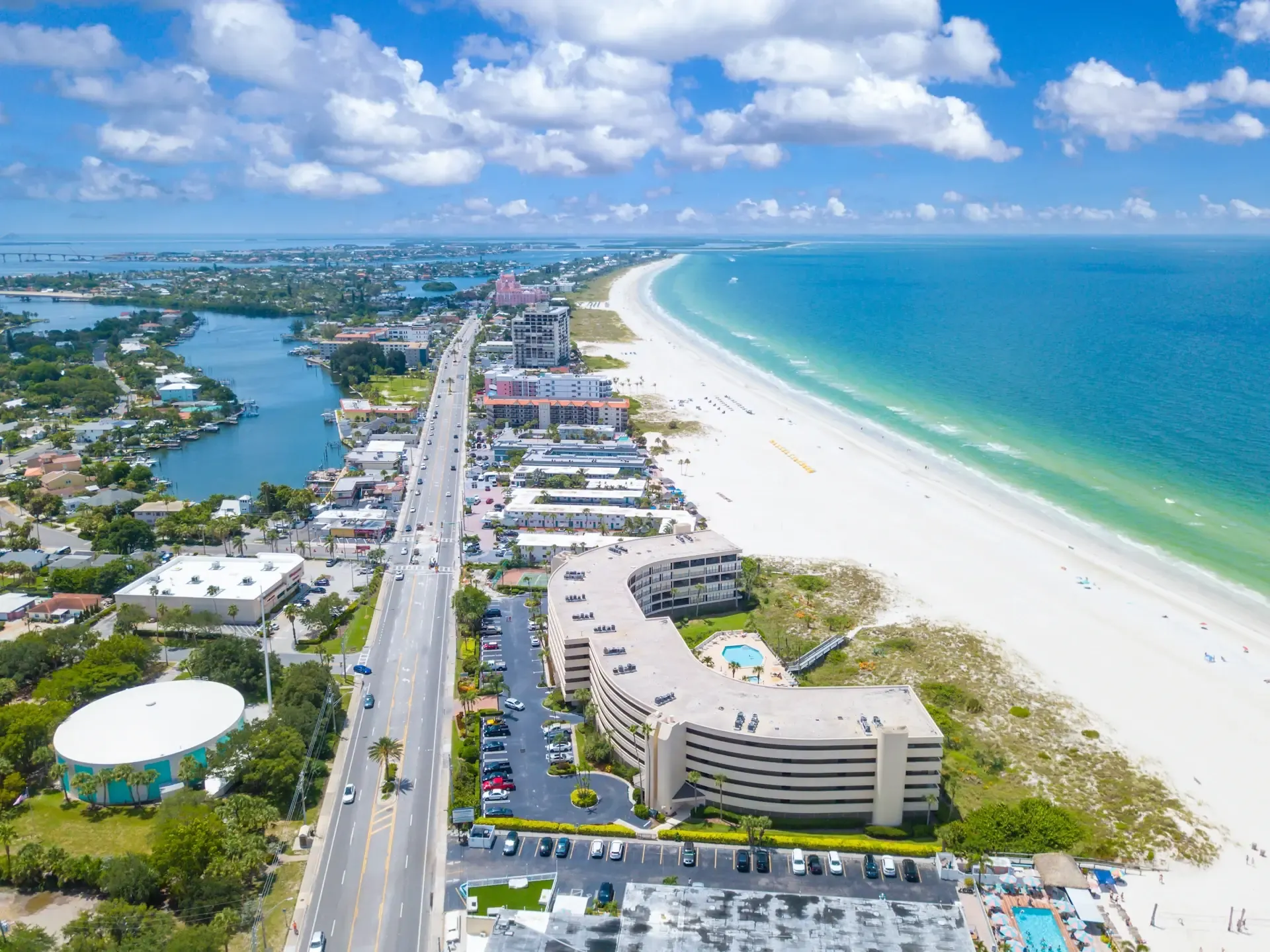 Aerial view of the St. Petersburg, Florida Gulf coastline with white-sand beach, waterfront condominiums, and Boca Ciega Bay